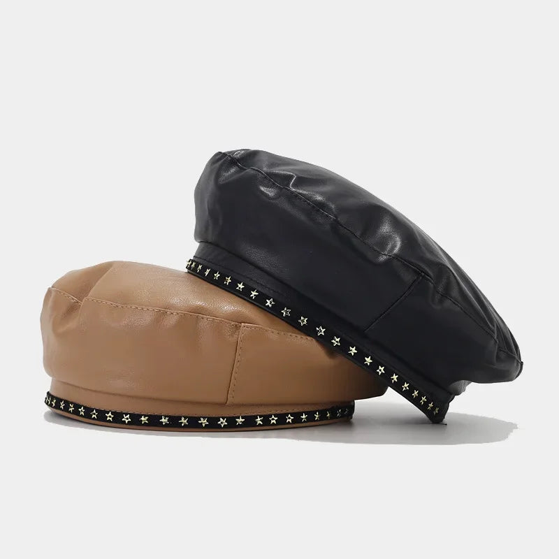 Two leather berets with star embellishments.