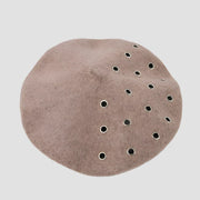 Taupe beret with grommets.
