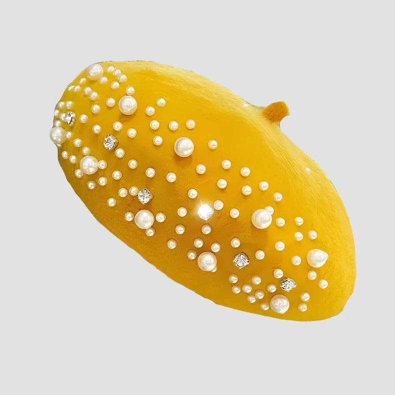 Yellow beret with pearls and rhinestones.