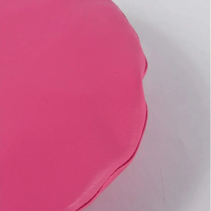 Hot pink, rounded, leather-like surface.