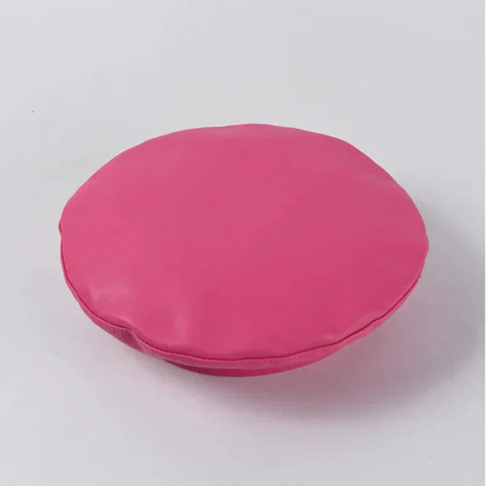 Round, pink, padded cushion.