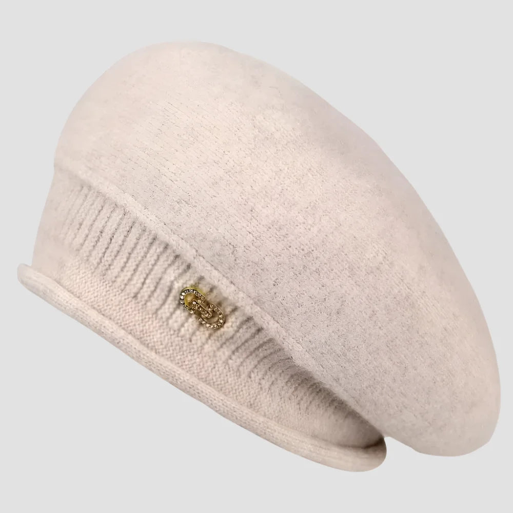 Beige knitted beret with embellishment.