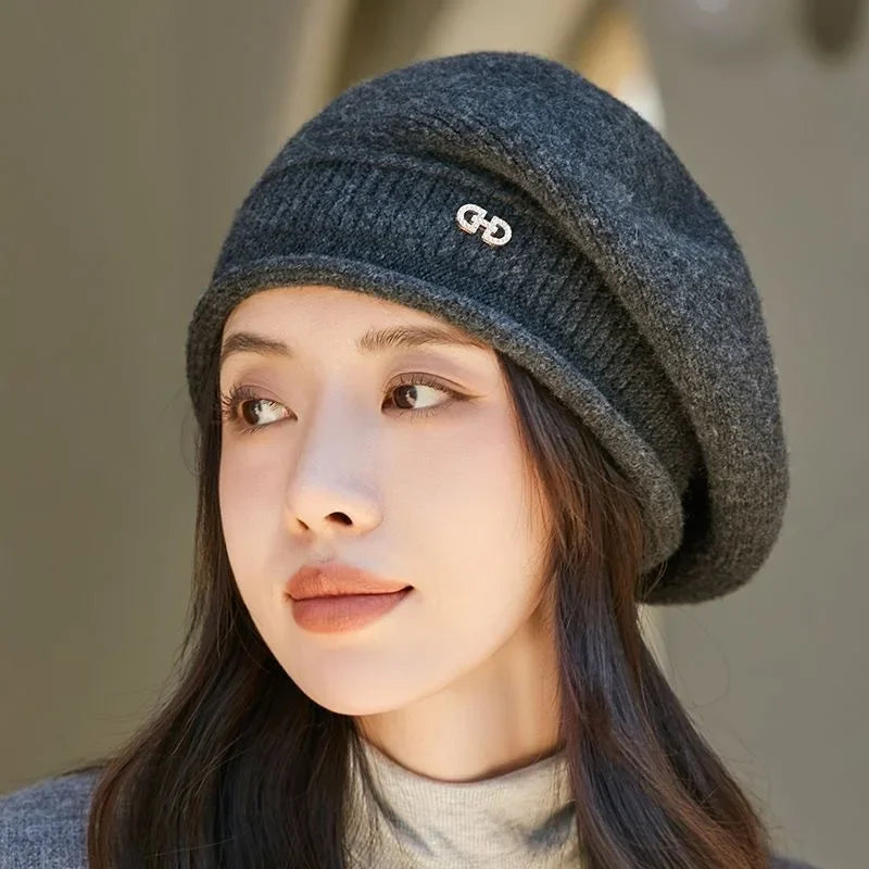 Gray knit beret with rhinestone embellishment.