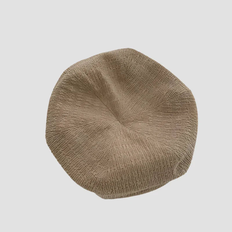 Beige knitted beret.