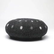 Gray felted beret with white polka dots.