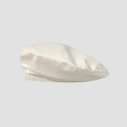 Cream-colored satin beret.