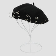 Black beret with silver rings.