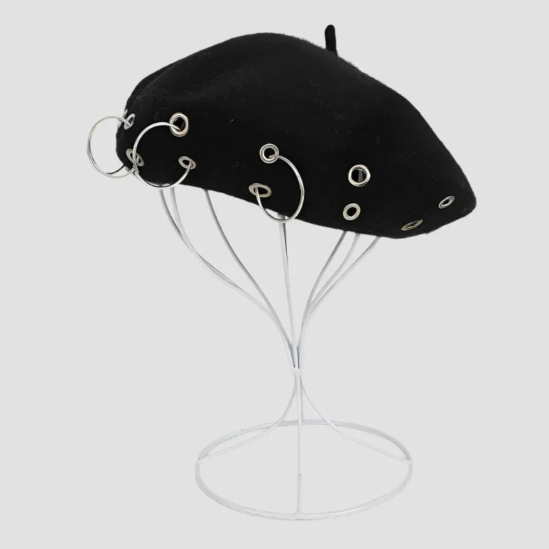 Black beret with silver rings.