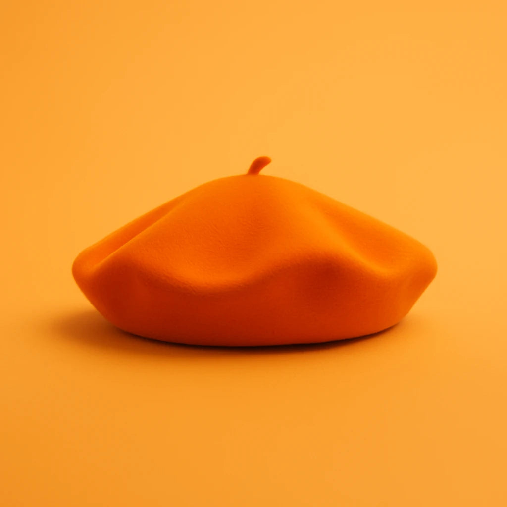 Fashionable orange beret made of soft wool – bold French hat design, perfect statement accessory for men and women
