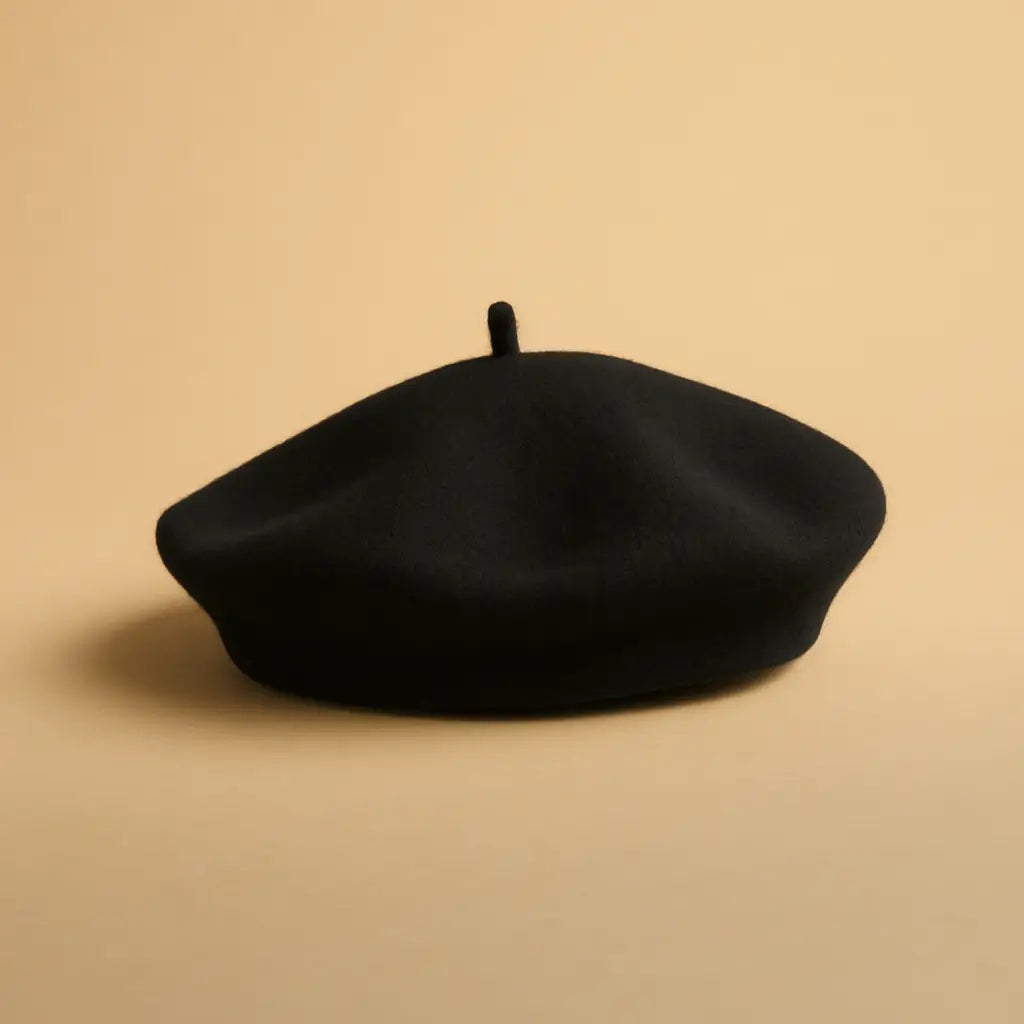 Black beret on a beige background