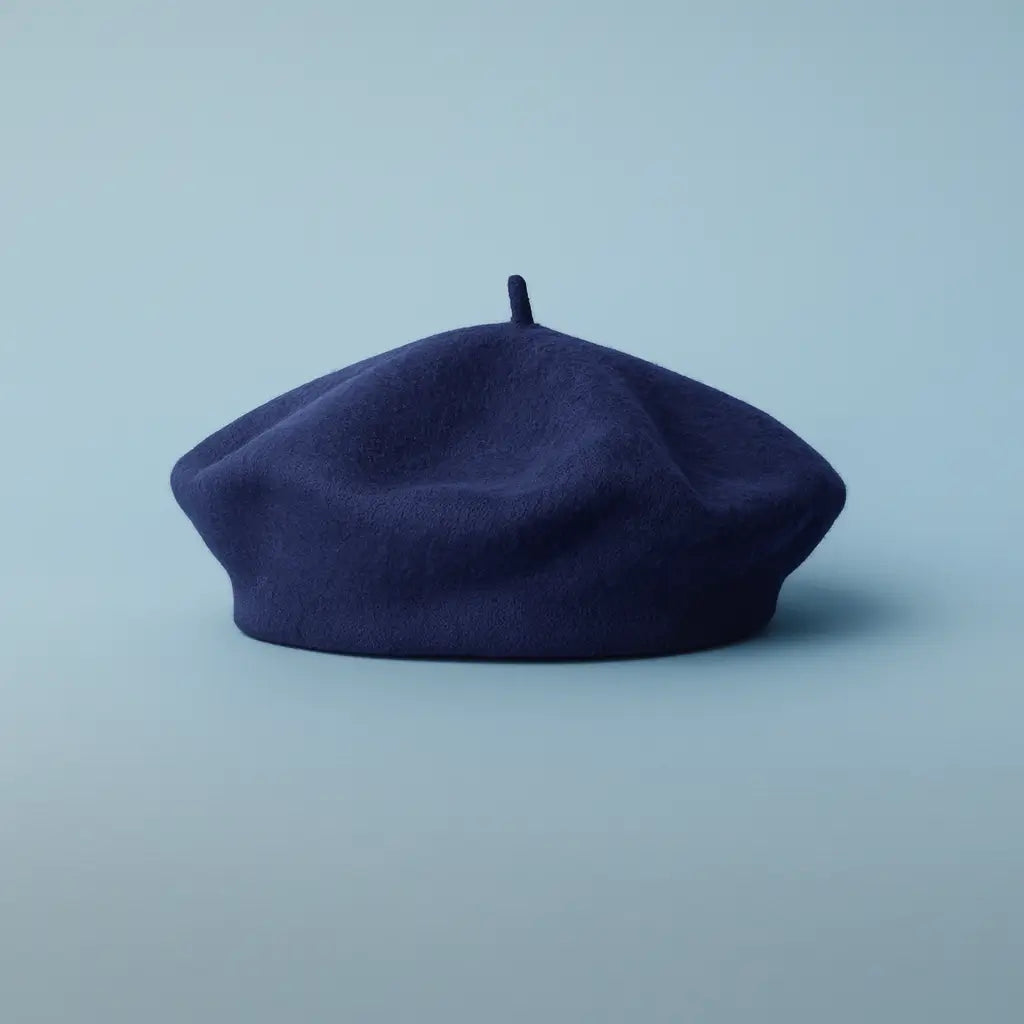 Navy blue beret on a light blue background