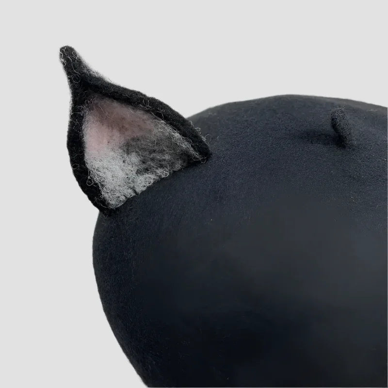 Black beret with cat ears.