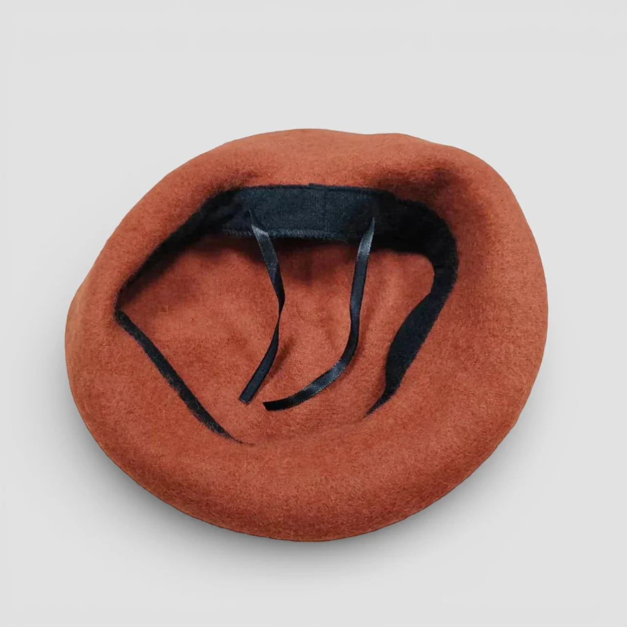 Animal Beret back view with rust-colored felt and black adjustable strap