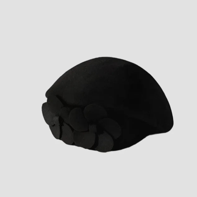 Black beret with decorative embellishments.