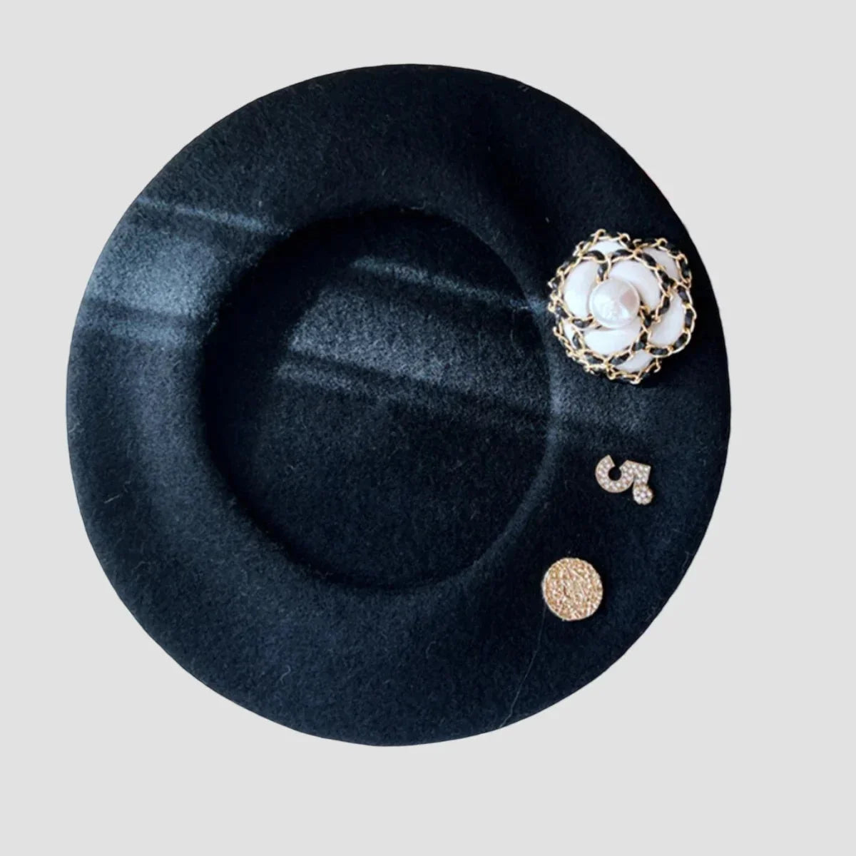 Basque style black felt beret with gold floral brooch and pearl