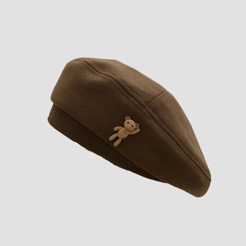 Brown beret with teddy bear accent.