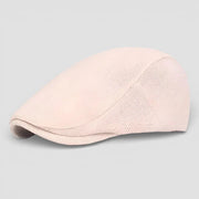 Soft blush pink flat cap beret with mesh side panel and curved brim