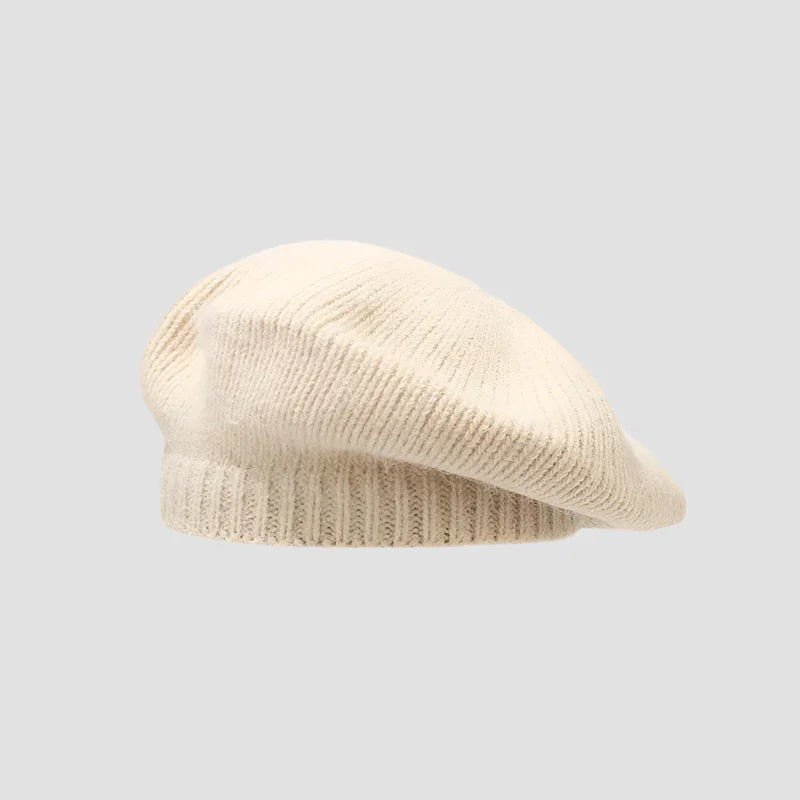 Cream-colored knitted beret.
