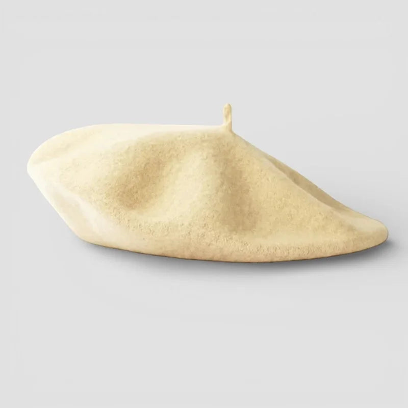 Cream-colored wool beret with textured surface and top button