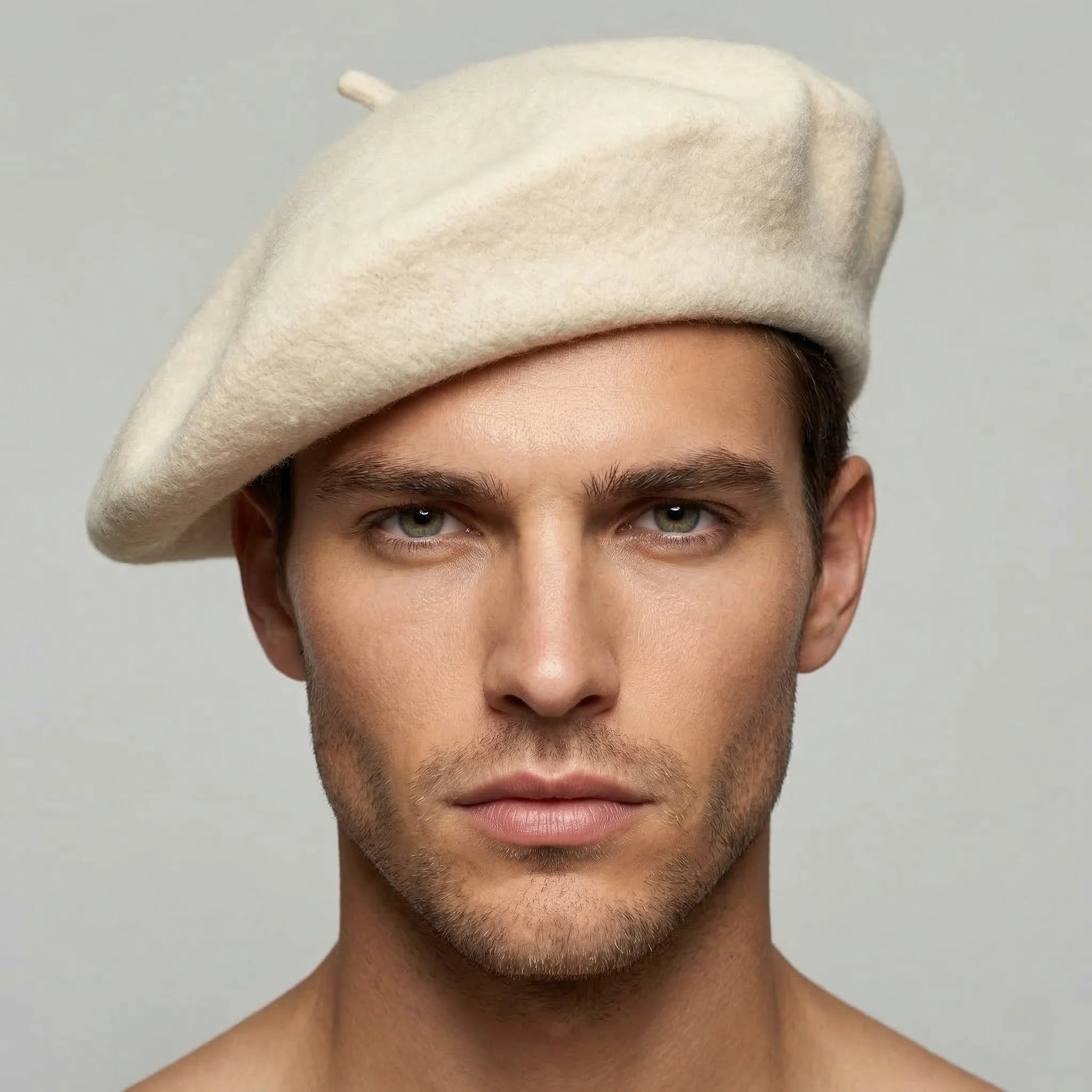 Cream-colored wool beret with textured surface and top button