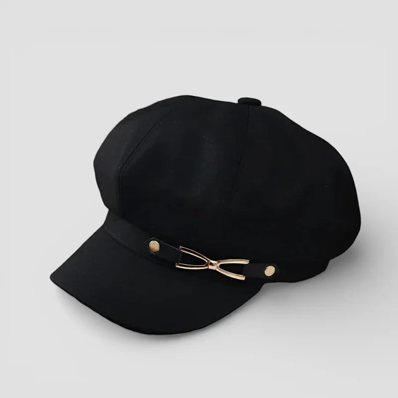 Black newsboy cap with gold bow clasp and button details