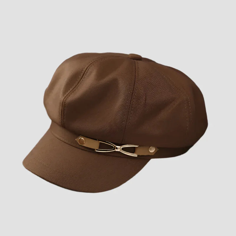 Brown baker boy hat with decorative buckle.