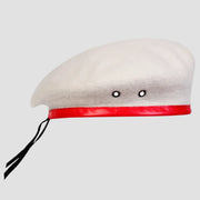 White graduation beret with red band.