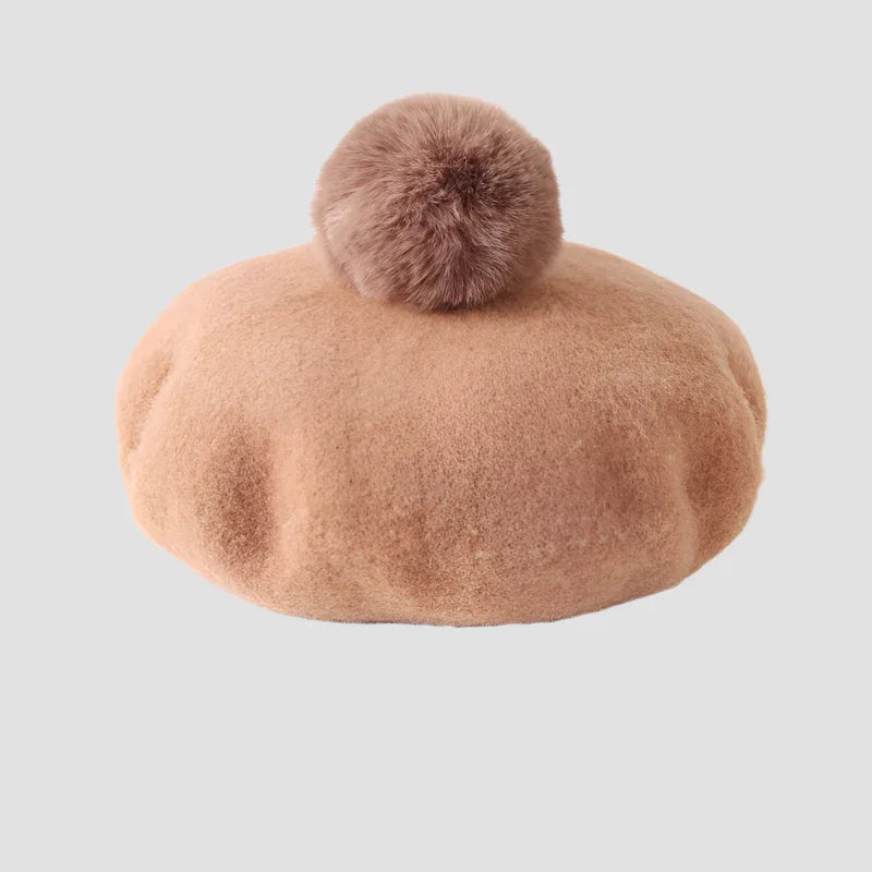 Fuzzy, light brown beret with pompom.