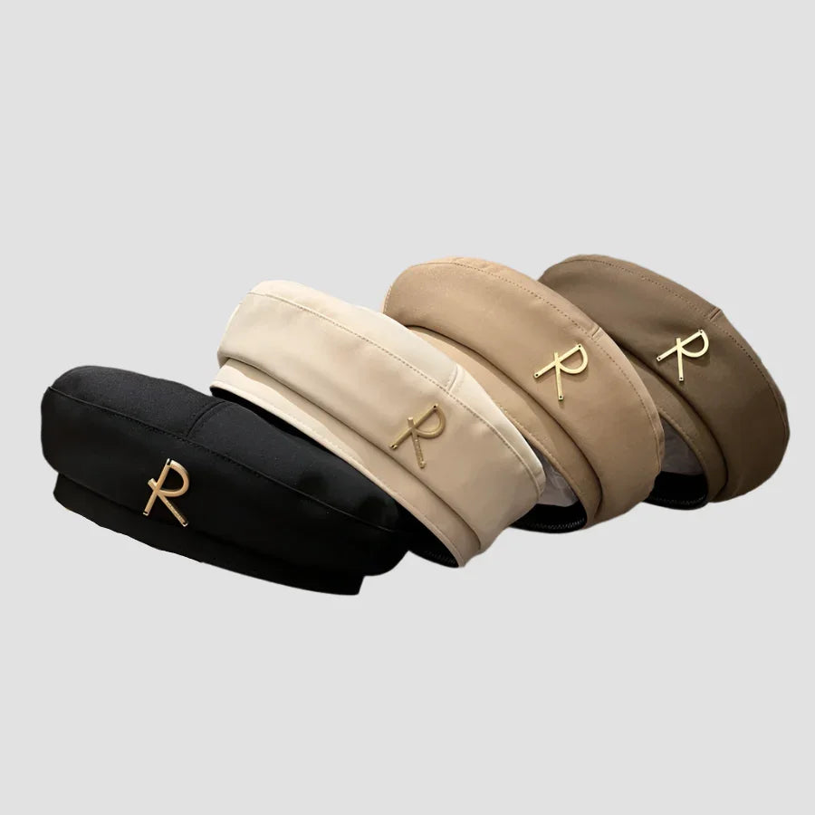 Four berets with gold ’R’ embellishments.