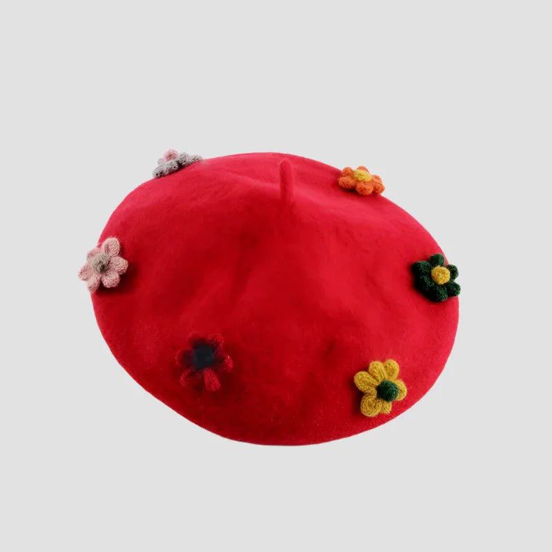 Red beret with colorful crocheted flowers.