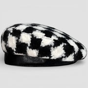Black and white houndstooth beret with fuzzy top and leather brim