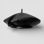 Black faux leather beret with glossy finish and central button
