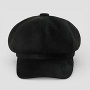 Black suede newsboy cap with structured flat brim and top button