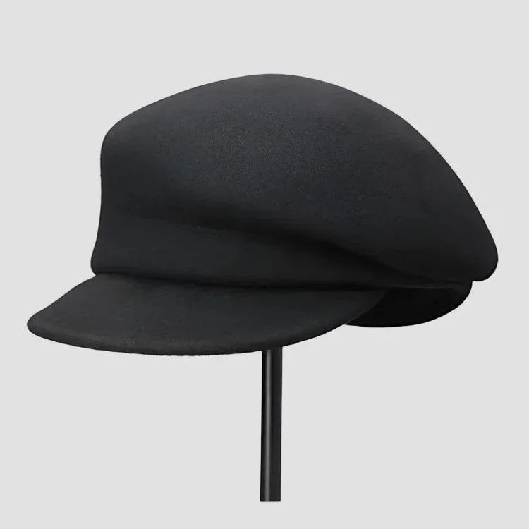 Black wool newsboy cap with structured curved brim and matte finish