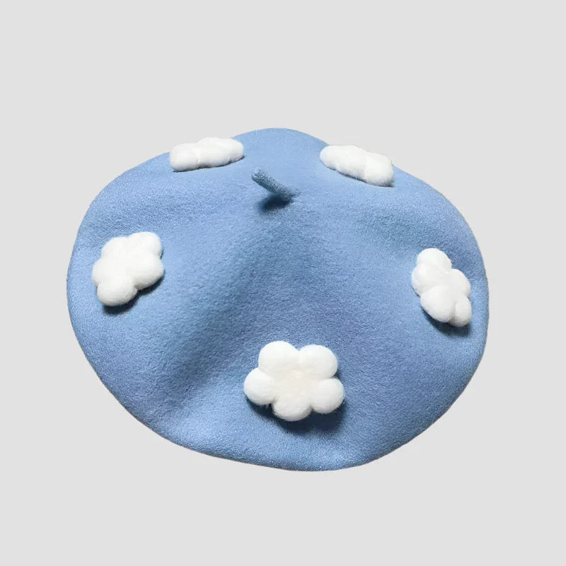 Light blue beret with white cloud accents.