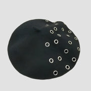 Black beret with silver grommets.