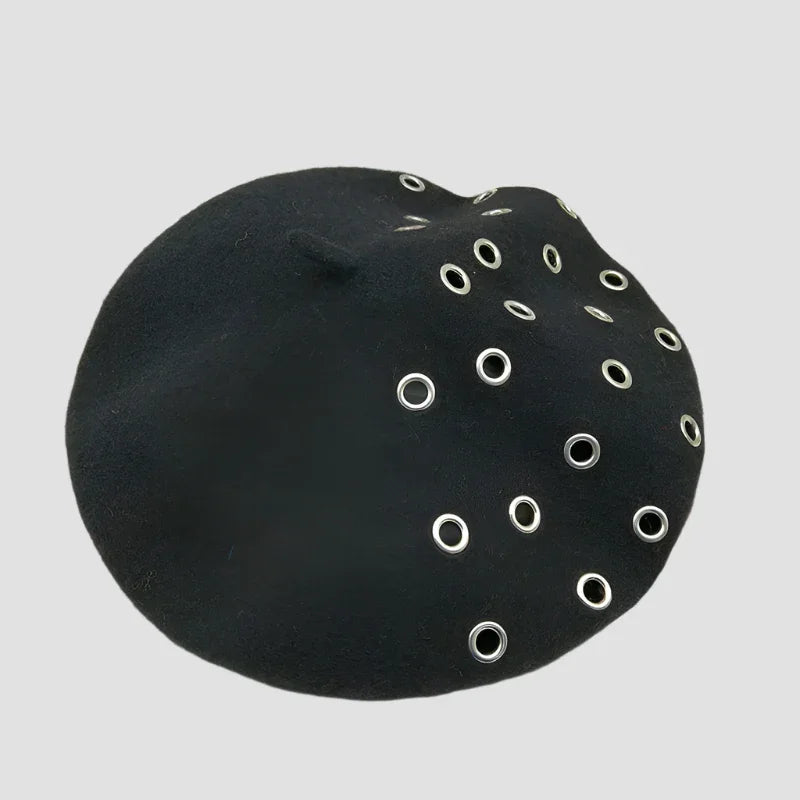 Black beret with silver grommets.