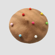 Brown beret with colorful pom-poms.