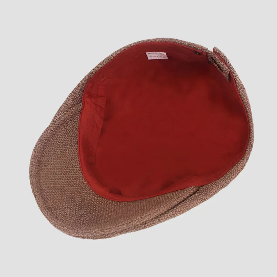 Brown tweed flat cap with red lining.