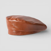 Sleek tan brown leather beret with glossy finish and subtle stitching