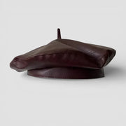 Dark brown leather beret with padded crown, button and brim
