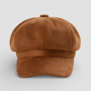 Brown newsboy cap in tan suede with structured brim and stitched seams