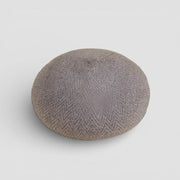 Gray textured ceramic button on brown wool beret