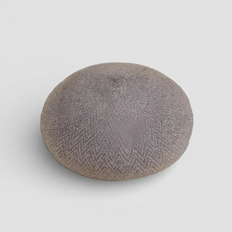 Gray textured ceramic button on brown wool beret