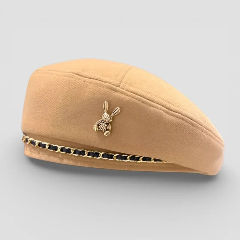 Bunny Beret: beige felt beret with gold-tone rabbit pin and black-gold chain trim