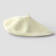 Classic French Beret in cream-colored wool with textured surface and top button