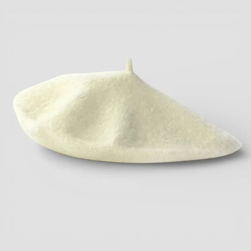 Classic French Beret in cream-colored wool with textured surface and top button