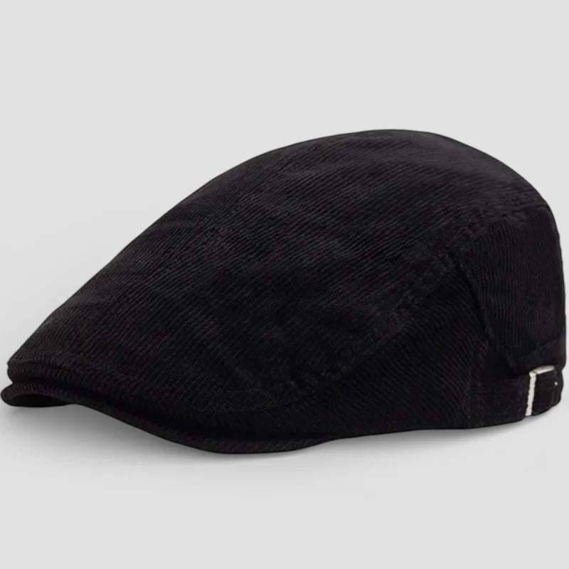 Black corduroy flat beret cap with subtle texture and silver side buckle