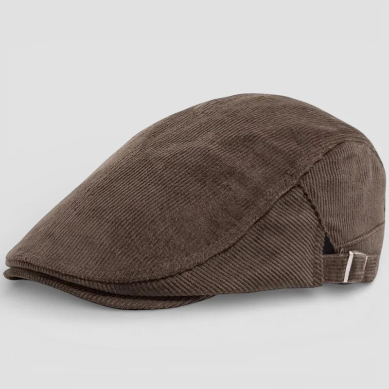 Brown corduroy flat cap with angled brim and adjustable strap