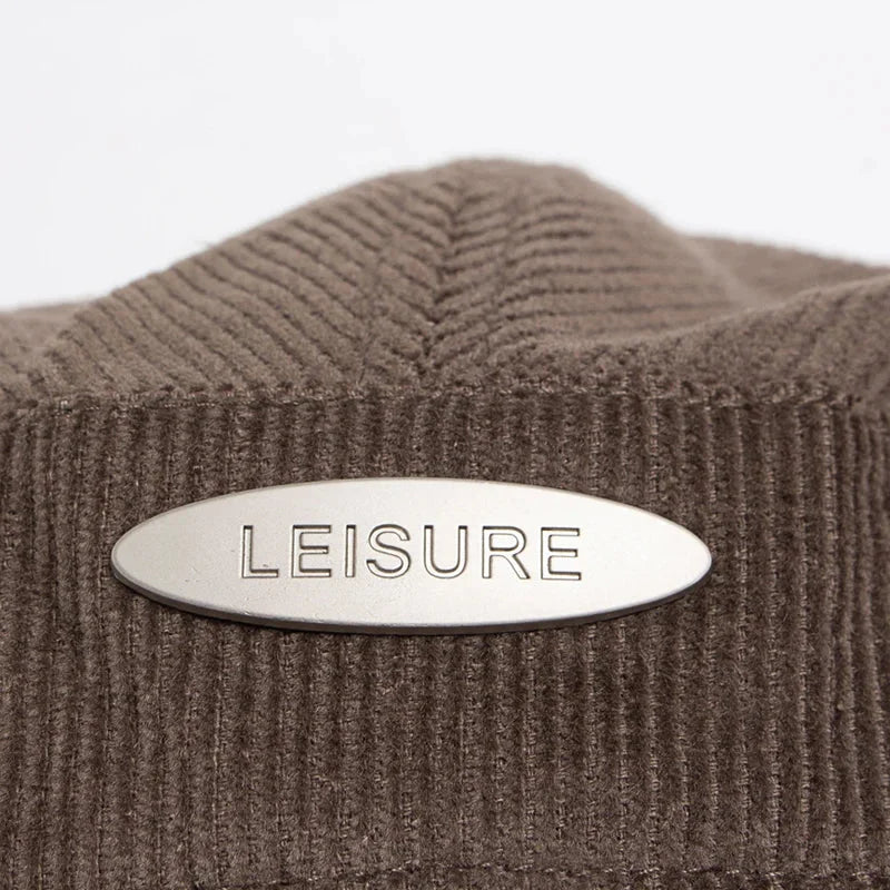 Brown corduroy hat with metal label.